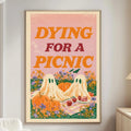 a poster with a Halloween theme, depicting two ghostly figures and a picnic scene, hanging on a wall in a living room.