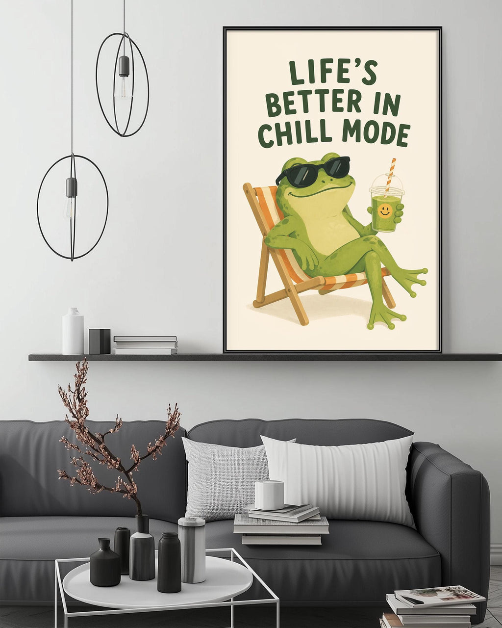 a cozy living room with a gray couch, a coffee table, and a framed poster of a frog sitting in a chair and holding a drink.