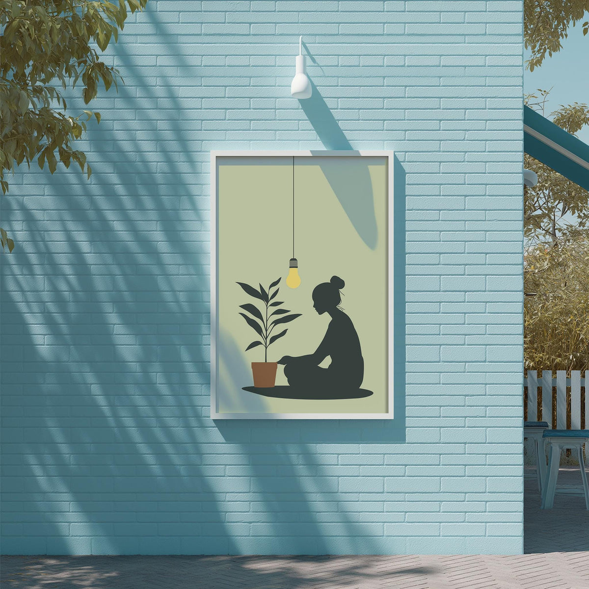 a woman sitting on the ground in front of a potted plant, with a light fixture hanging above her.