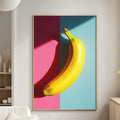 a vibrant and colorful painting of a banana hanging on a wall in a modern living room.