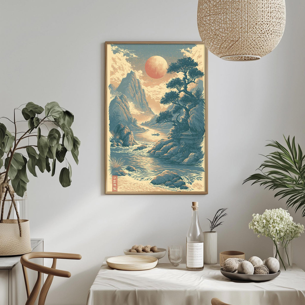 a serene landscape with a large sun in the sky, surrounded by mountains, trees, and a calm body of water. The scene is framed and hung on a wall, creating a focal point in the room. The table is set with various items, including a bottle, a bowl, and a vase, suggesting a dining or gathering area. The room is decorated with potted plants and other natural elements, creating a peaceful and harmonious atmosphere.