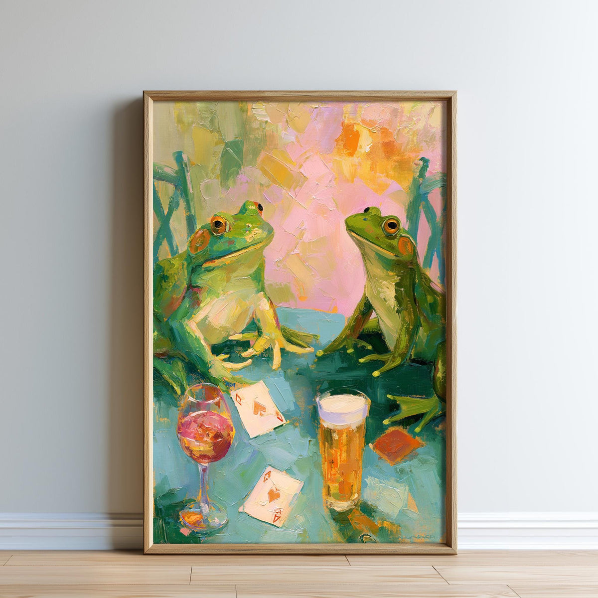 The image is a painting depicting two green frogs sitting at a table with a glass of wine and playing cards.