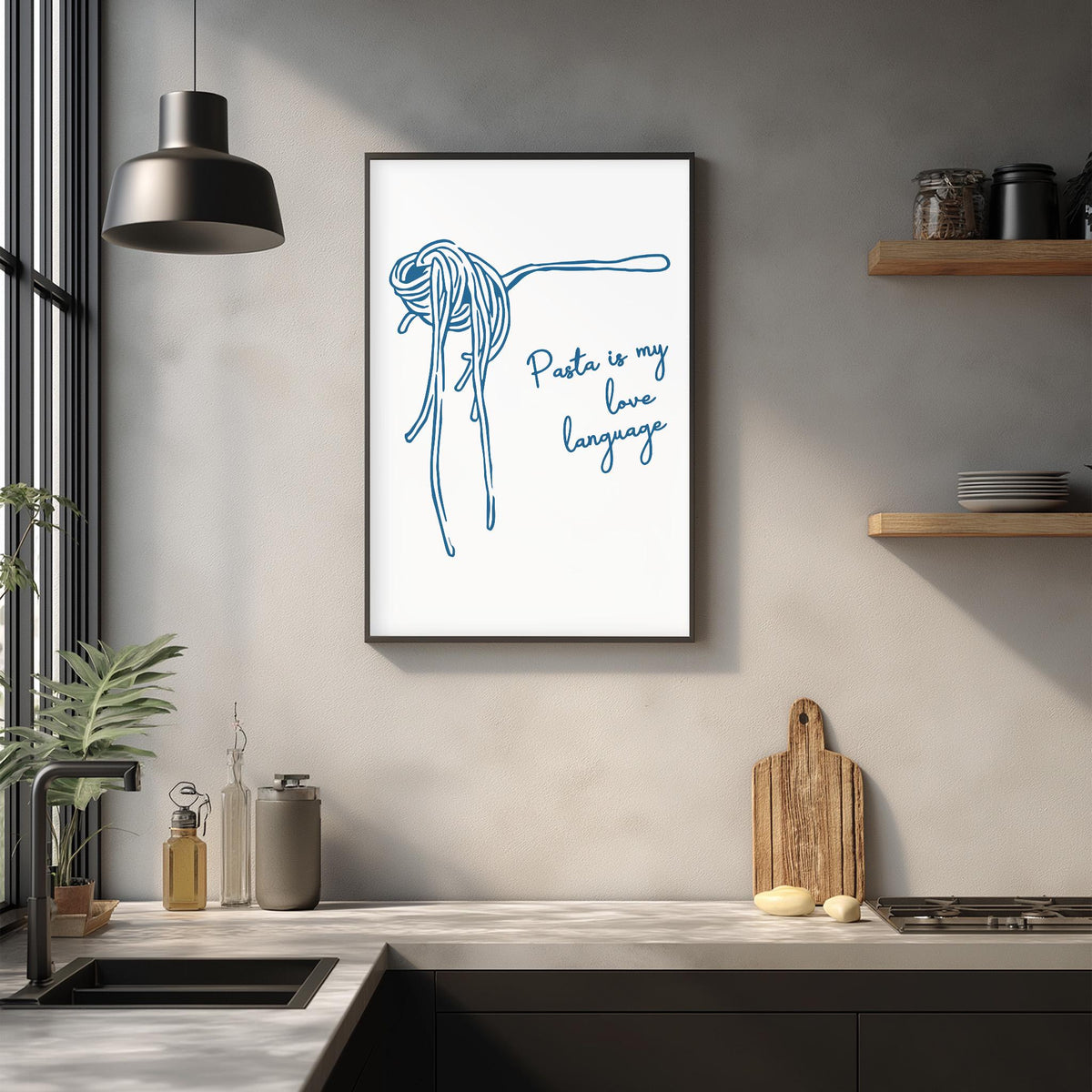 a framed poster with a drawing of spaghetti noodles and the text "Pasta is my love language" hanging on a wall above a kitchen counter.