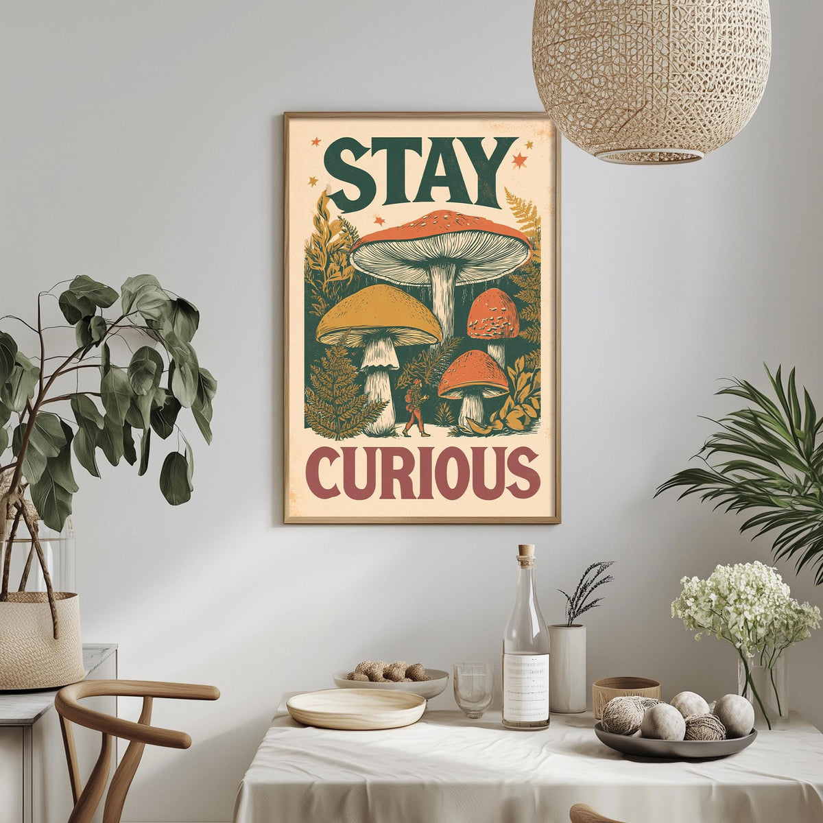 a framed poster with the text "STAY CURIOUS" hanging on a wall above a dining table with various items on it, including a bottle, a bowl, and a vase.