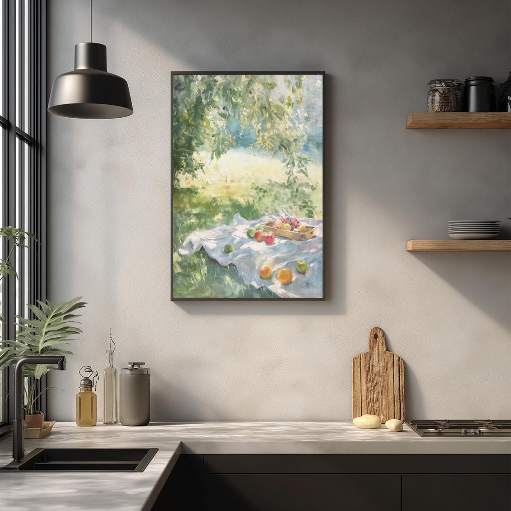 a kitchen counter with a framed painting of a picnic scene hanging above it. The painting depicts a picnic with a blanket, fruit, and a basket of food. The kitchen counter has various items on it, including a cutting board, a bottle, and a bowl.