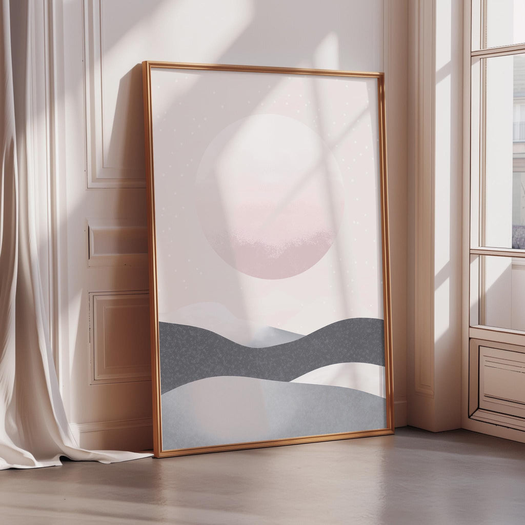 a large, framed artwork depicting a serene landscape with mountains and a sunset.