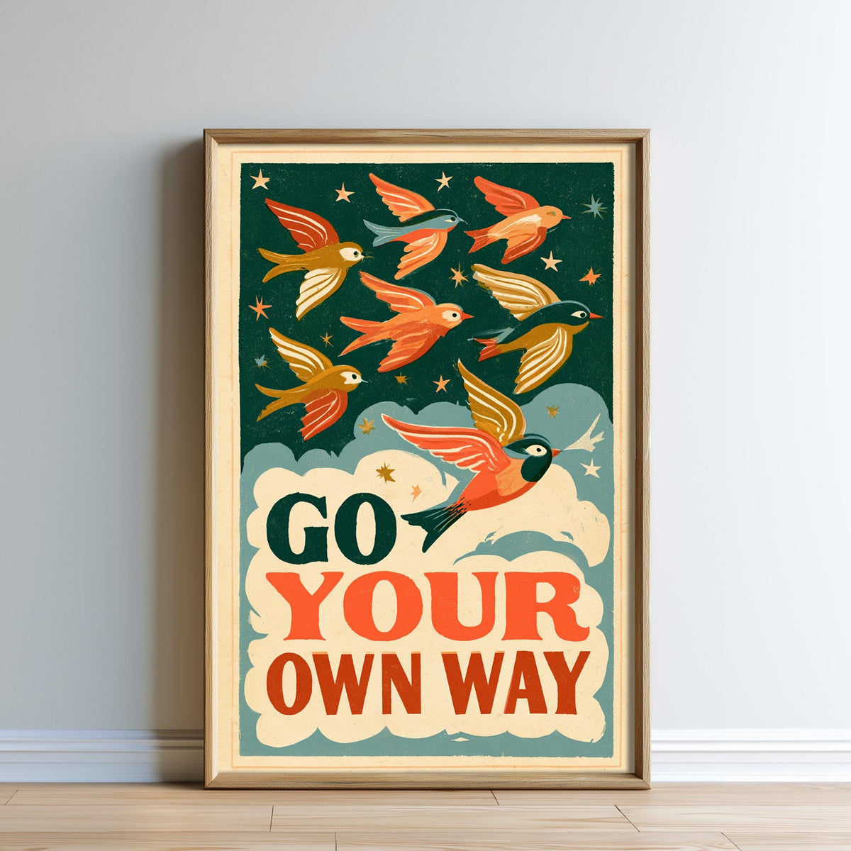 The image is a framed poster with a vibrant illustration of birds flying against a starry night sky background. The poster features the text "GO YOUR OWN WAY" prominently displayed.