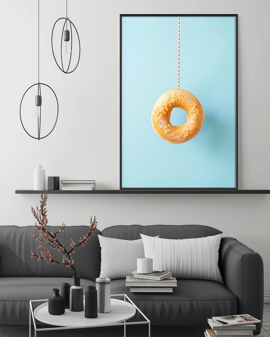 a modern living room with a gray sofa, a coffee table, and a large framed picture of a donut hanging on the wall.