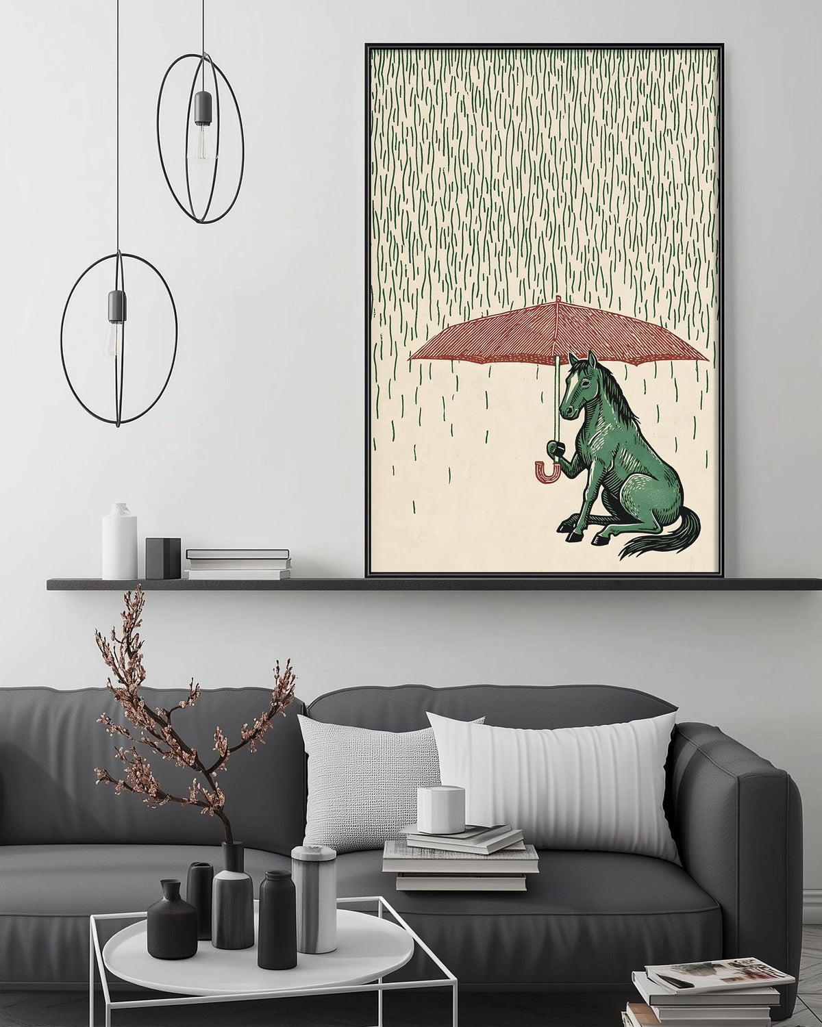 a living room with a gray couch, a coffee table, and a large framed illustration of a green horse sitting under an umbrella, surrounded by falling green leaves.