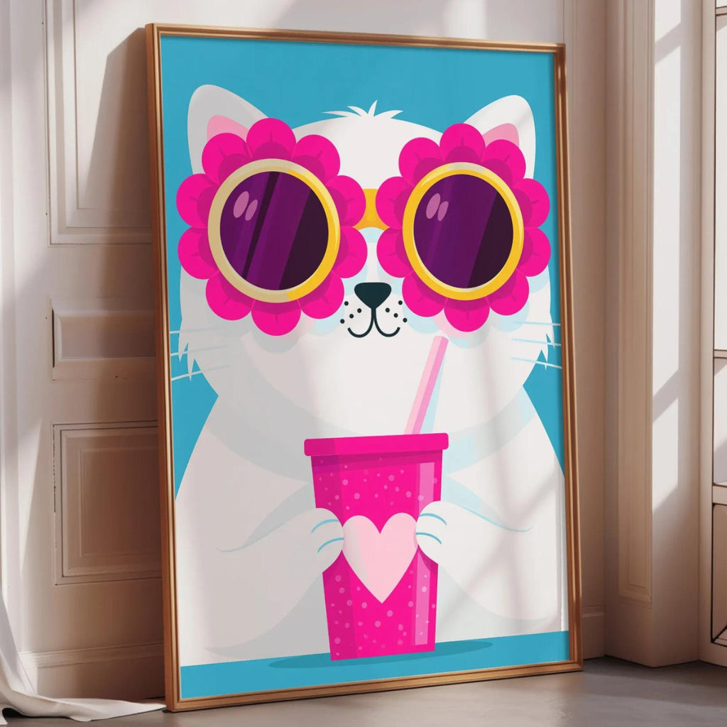 A framed poster of a white cat wearing pink sunglasses and holding a pink cup with a heart on it, placed on a wall near a window.