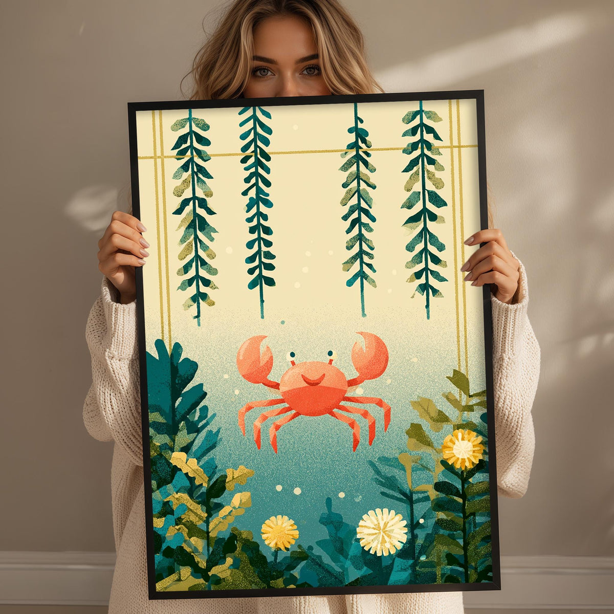 A woman holds up a framed print featuring a vibrant underwater scene with a crab, plants, and flowers.
