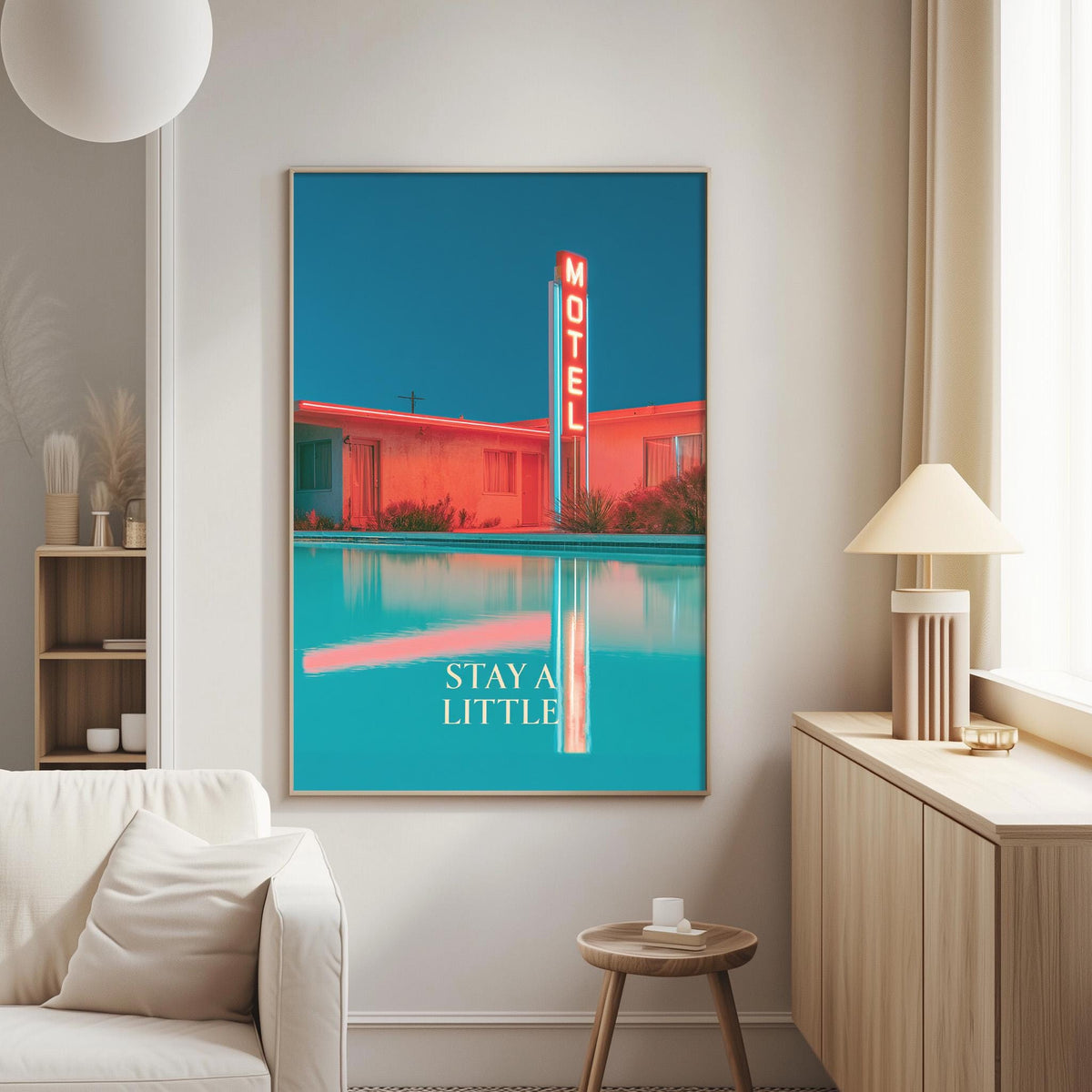 a large framed poster of a motel with a neon sign, hanging on a wall in a living room.
