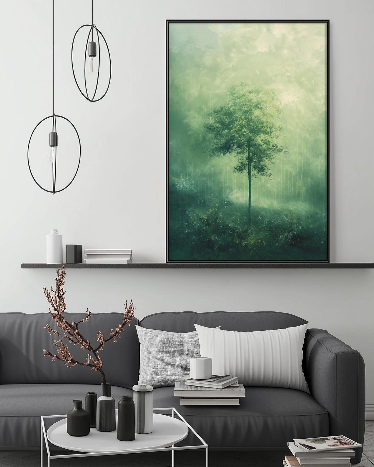 a modern living room with a gray sofa, a coffee table, and a large framed landscape painting depicting a tree in a misty forest.