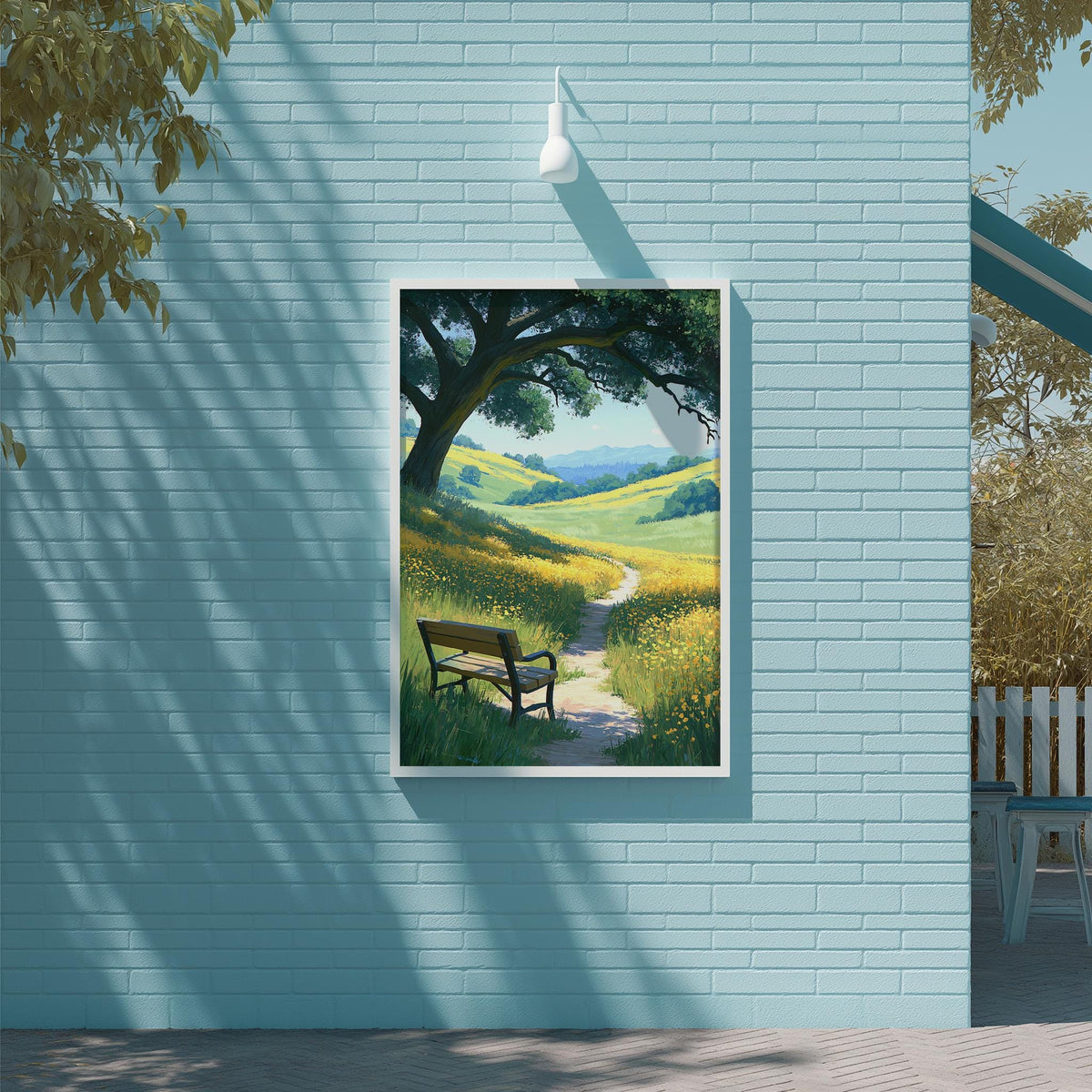 A framed painting depicting a serene landscape with a path leading through a field of flowers, framed on a light blue wall.