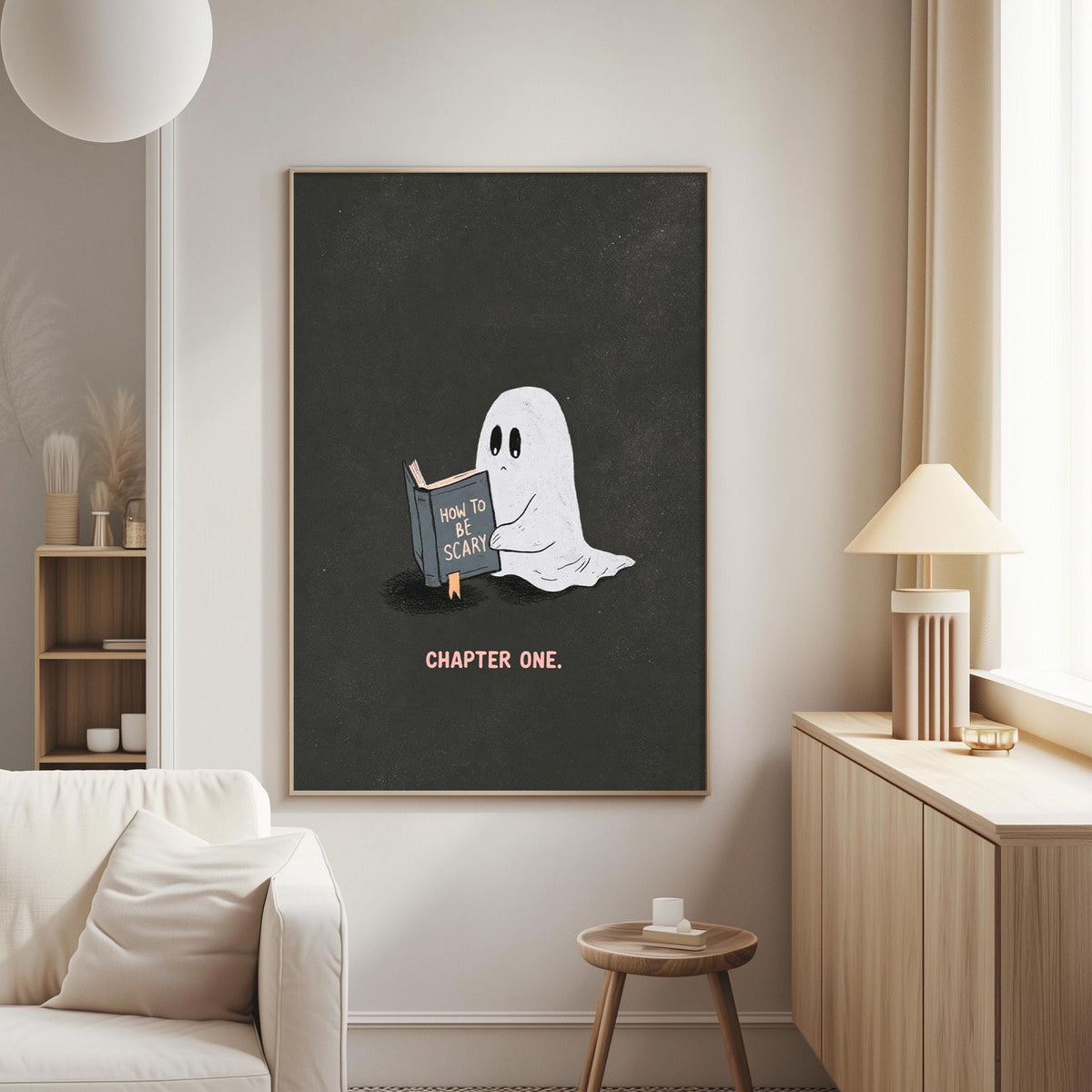 a poster of a ghost reading a book titled "How to Be Scary" on a wall in a living room.