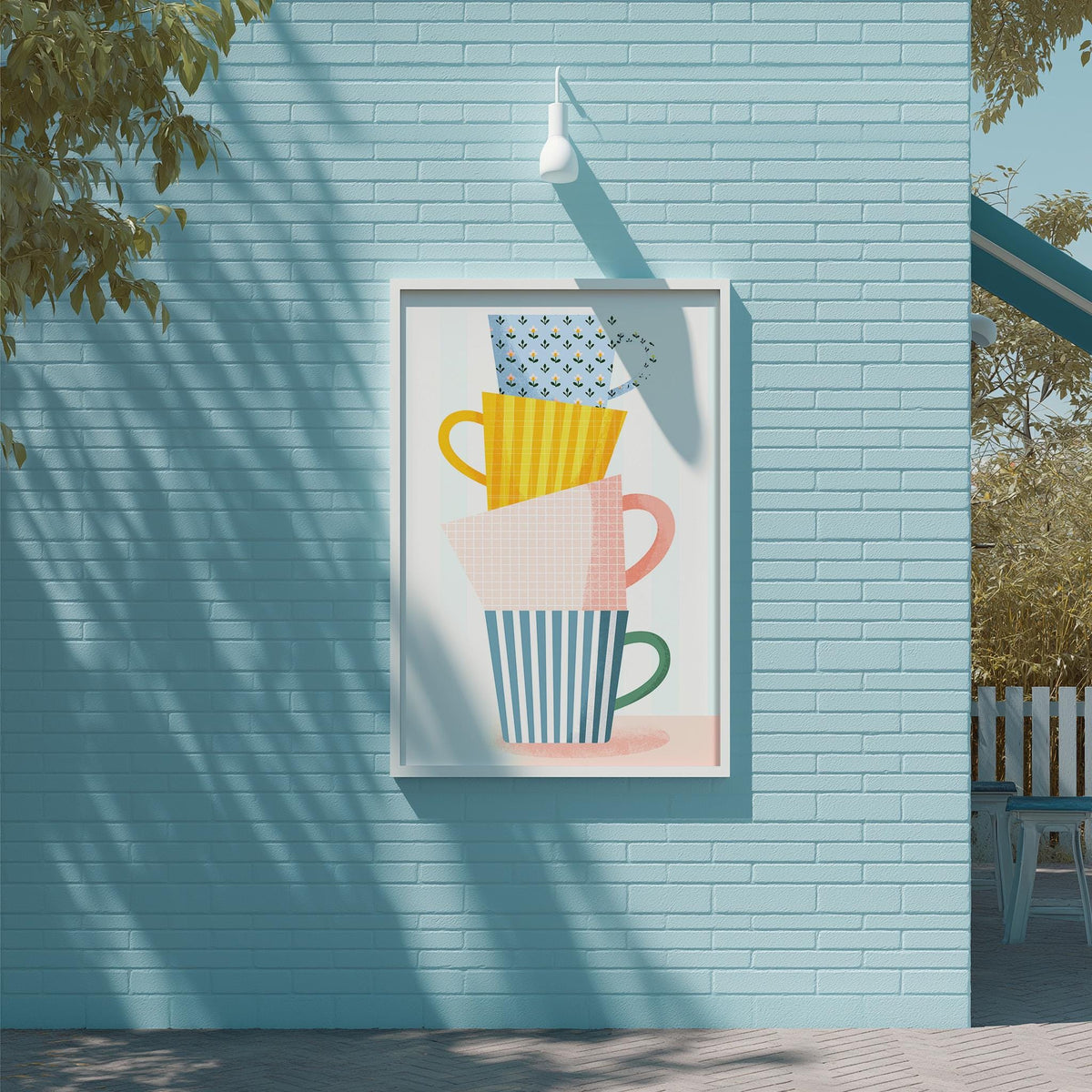 a vibrant and colorful poster of stacked cups on a blue wall, with a white light fixture above it.