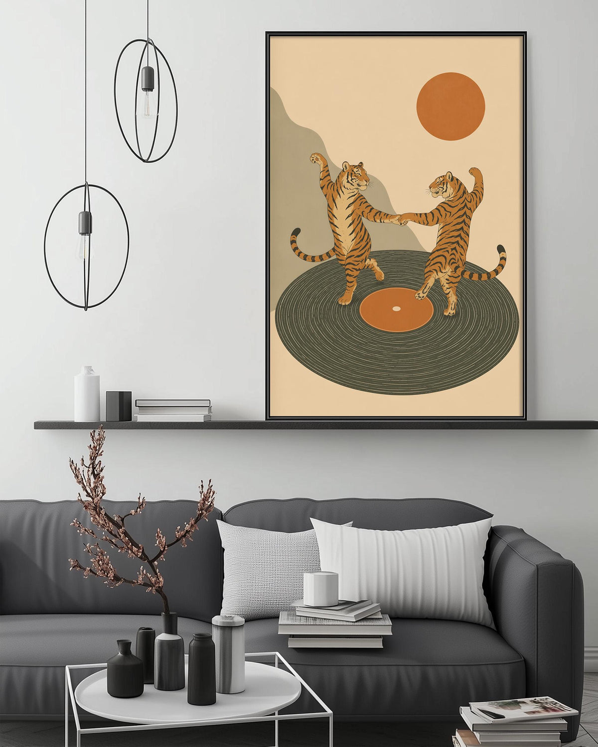 a modern living room with a gray sofa, a coffee table, and a framed illustration of two dancing tigers on a record player.