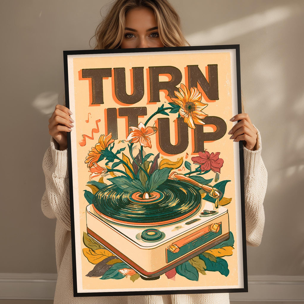 A woman holding a framed poster with a vintage-style design featuring a record player surrounded by flowers and leaves.