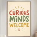 a poster with the text "CURIOUS MINDS WELCOME" in a warm color palette, hanging on a wall in a living room setting.
