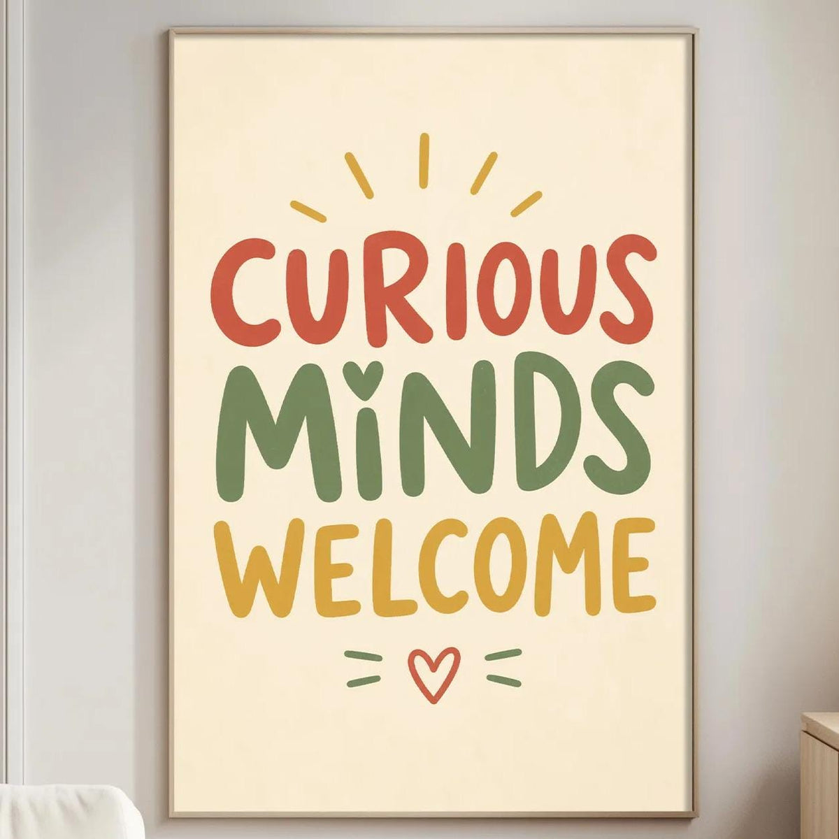 a poster with the text "CURIOUS MINDS WELCOME" in a warm color palette, hanging on a wall in a living room setting.