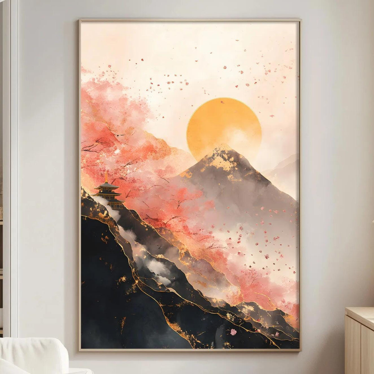 a large framed painting of a mountain landscape with a sunset in the background, hanging on a wall in a living room setting.