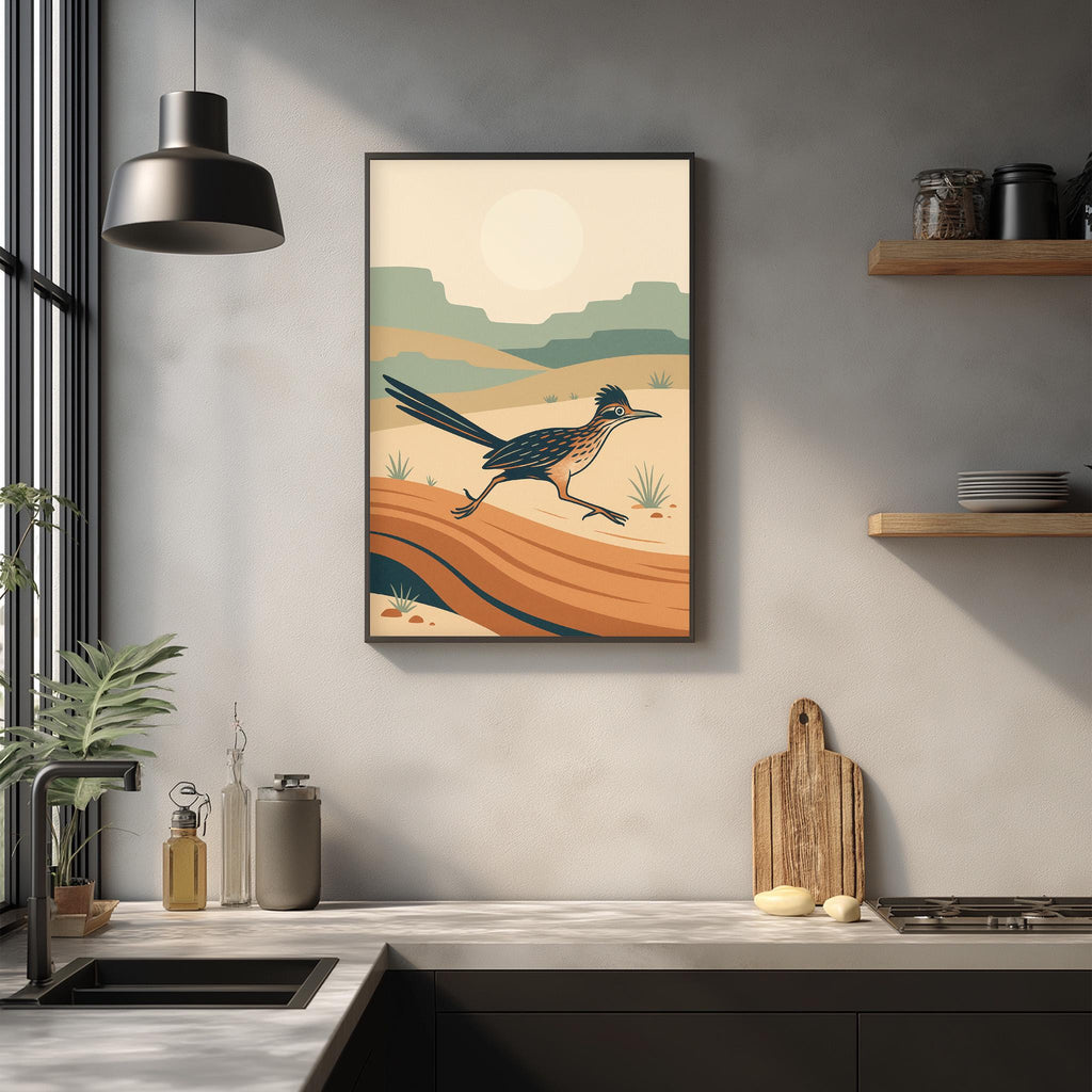 a kitchen counter with various kitchen items, including a cutting board, a bottle, and a vase. Above the counter, there is a framed illustration of a bird, likely a roadrunner, in a desert landscape.