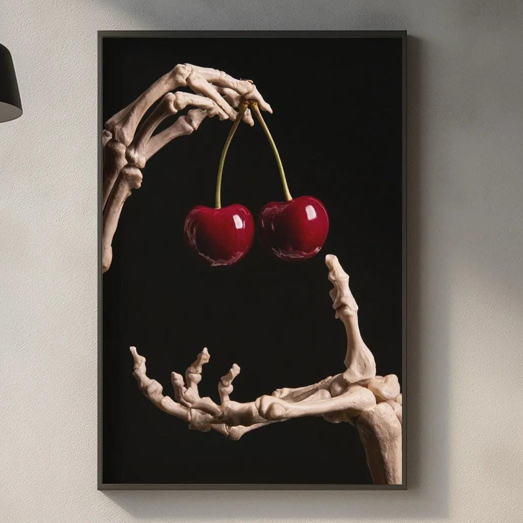 a skeleton hand holding two cherries, with the skeleton's bones forming the shape of the cherries. The skeleton hand is positioned over a kitchen counter, which has various kitchen items such as a cutting board, a bottle, and a bowl.