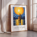 The image is a framed poster of Vincent Van Gogh's painting "Starry Night". The painting depicts a man and a child standing together under a starry sky. The poster is placed on a white wall, and there is a curtain visible in the background.
