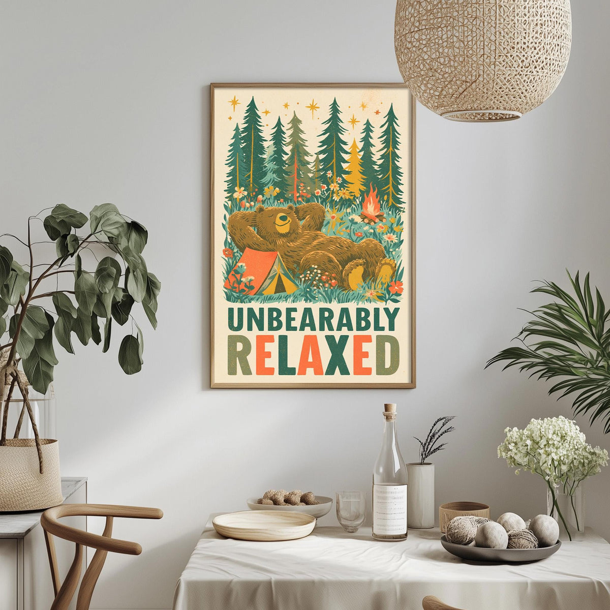 a framed poster with a bear and camping scene, hanging on a wall above a dining table with various items on it.