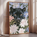 A framed painting of a black panther surrounded by colorful flowers is displayed on a wall in a room.