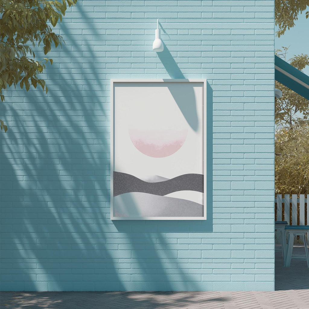 a blue brick wall with a framed artwork depicting a landscape scene, including mountains and a sun.