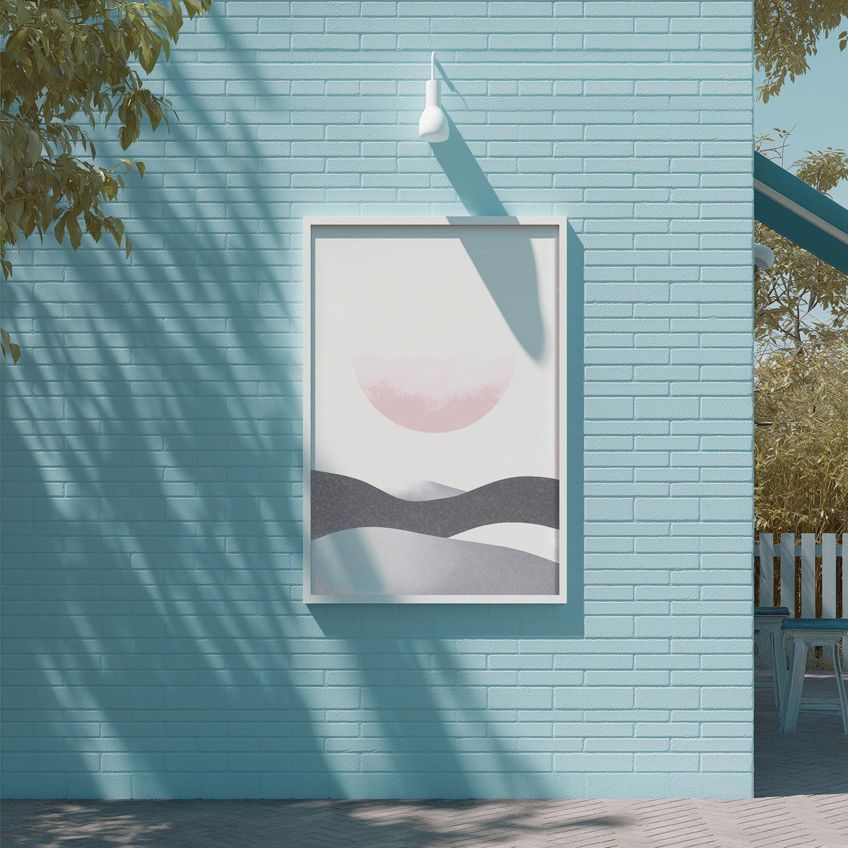 a blue brick wall with a framed artwork depicting a landscape scene, including mountains and a sun.