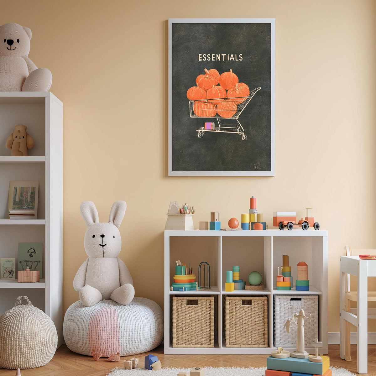 A cozy children's room with a white bookshelf, a plush rabbit, and a storage unit filled with toys and baskets. A framed poster of pumpkins in a shopping cart hangs on the wall, and a shelf holds various stuffed animals.