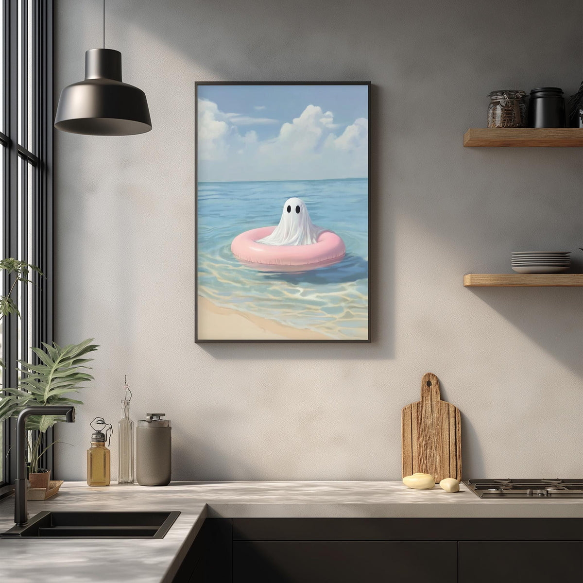 a framed painting of a ghost floating on a pink inner tube in the ocean, hanging on a wall above a kitchen counter.