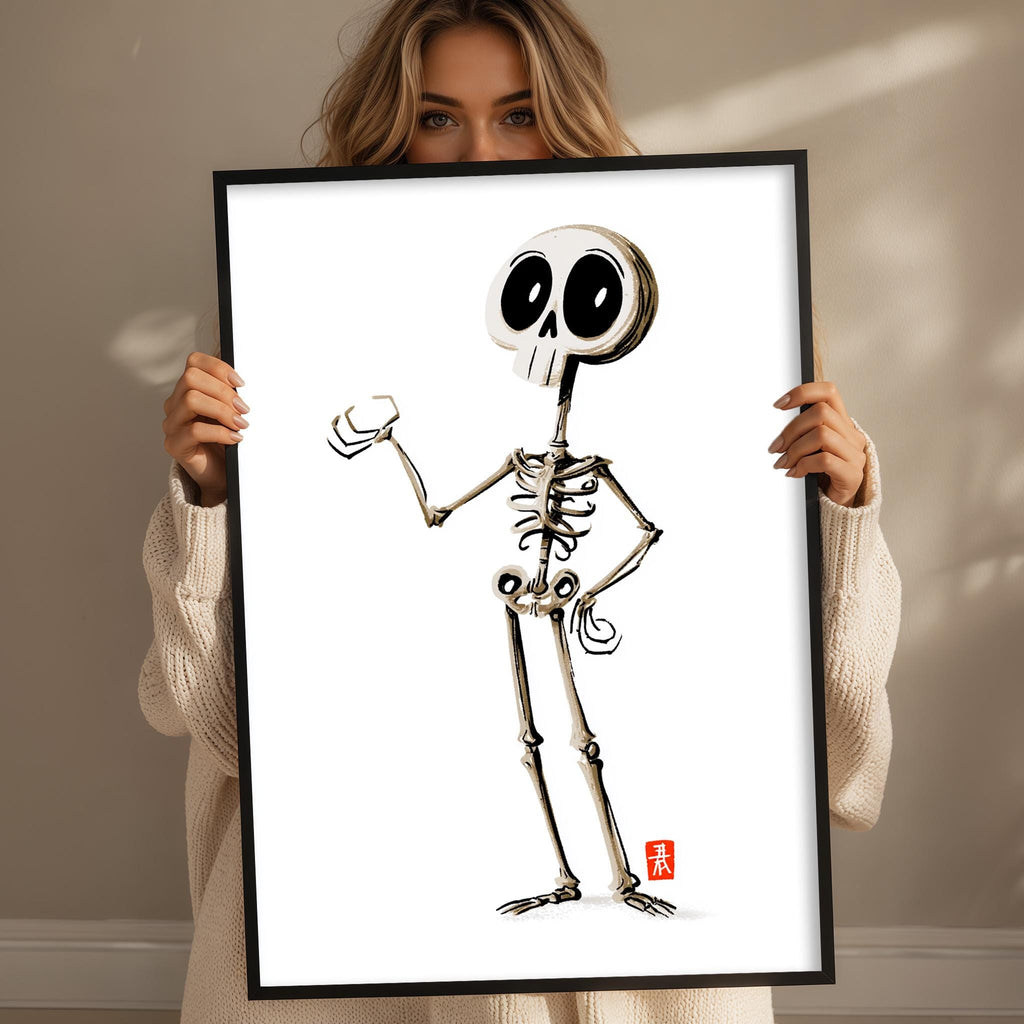 A woman is holding up a framed illustration of a skeleton with a cartoon-like style.