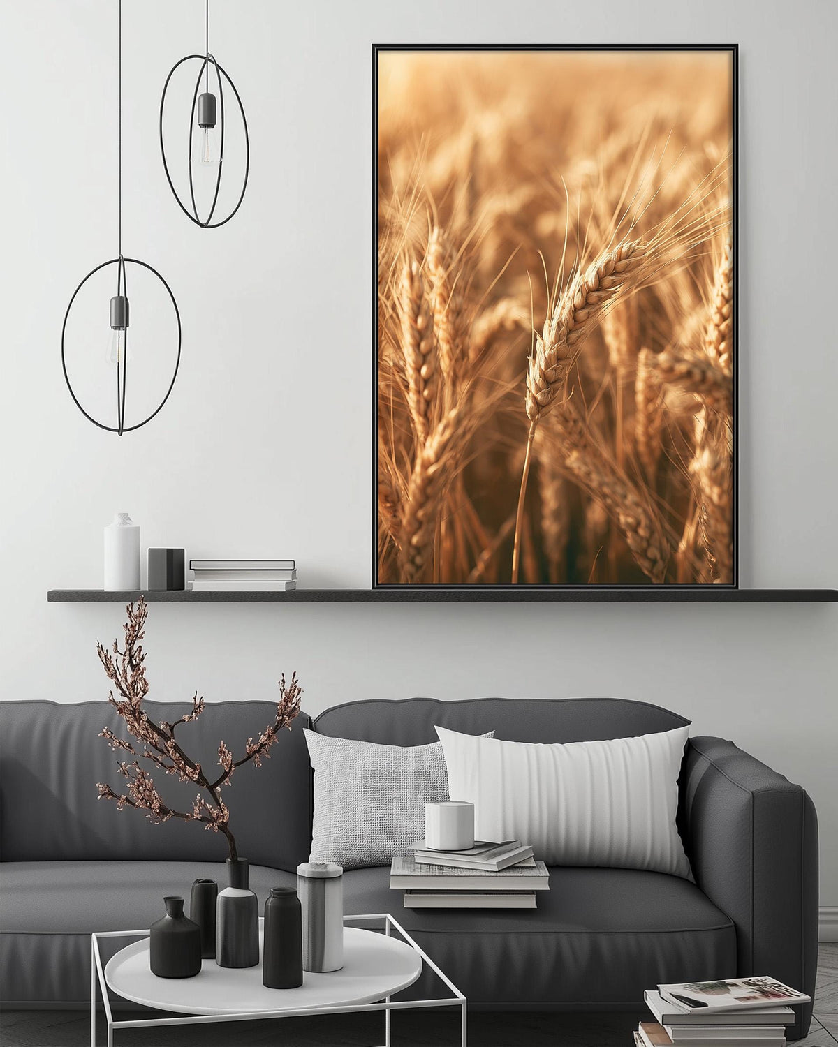 a living room with a gray sofa, a coffee table, and a large framed picture of wheat fields hanging on the wall above the sofa.
