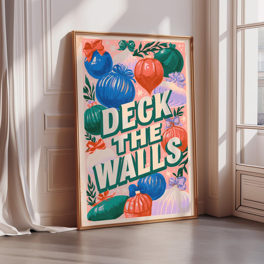 A framed poster with a colorful design featuring various decorative elements, including pumpkins, flowers, and other festive ornaments. The text on the poster reads "DECK THE WALLS".
