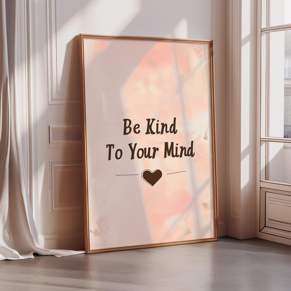 A framed poster with the text "Be Kind To Your Mind" and a heart symbol is displayed on a wall in a room with sunlight streaming in through a window.