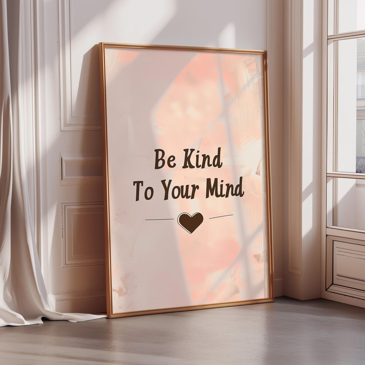 A framed poster with the text "Be Kind To Your Mind" and a heart symbol is displayed on a wall in a room with sunlight streaming in through a window.