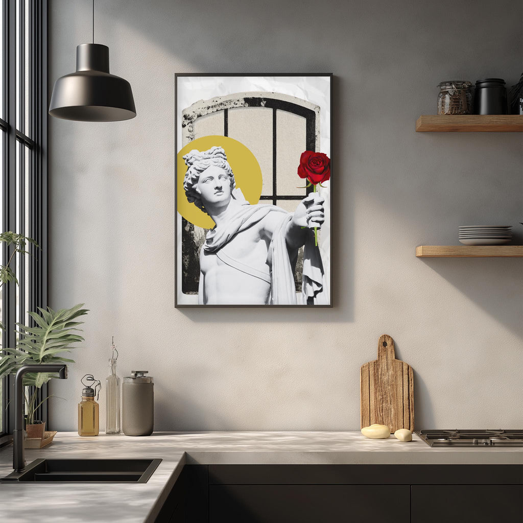 a modern kitchen with a framed artwork of a statue holding a red rose above a window. The kitchen counter has various items such as a cutting board, a soap dispenser, and a bottle.
