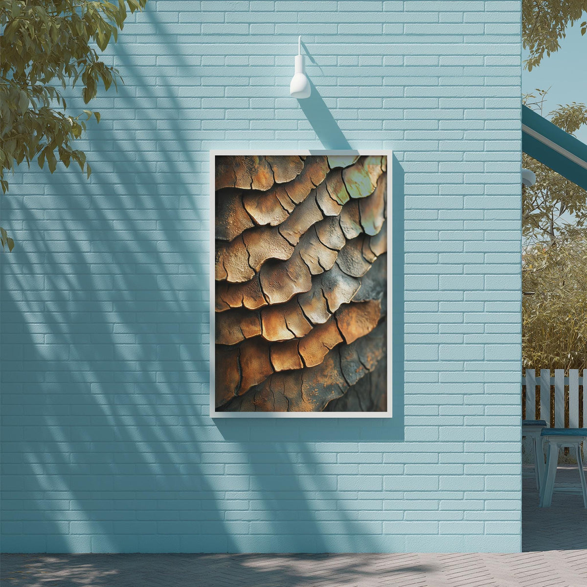 a blue brick wall with a framed photograph of a textured surface hanging on it.