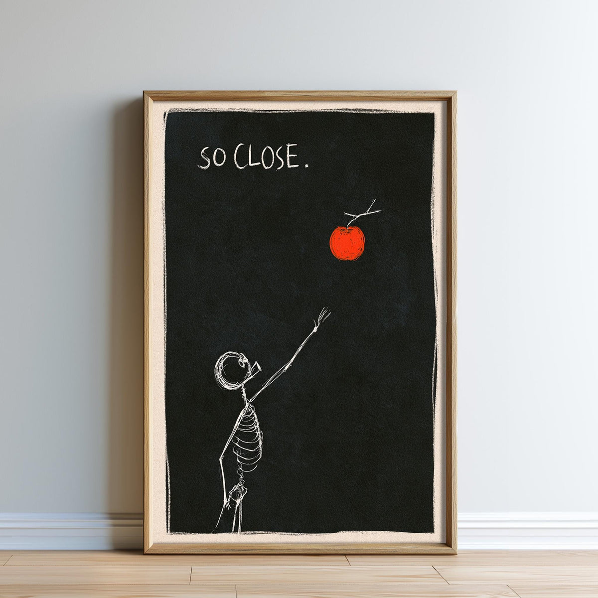 The image is a framed artwork depicting a skeleton reaching up towards a red apple against a black background.