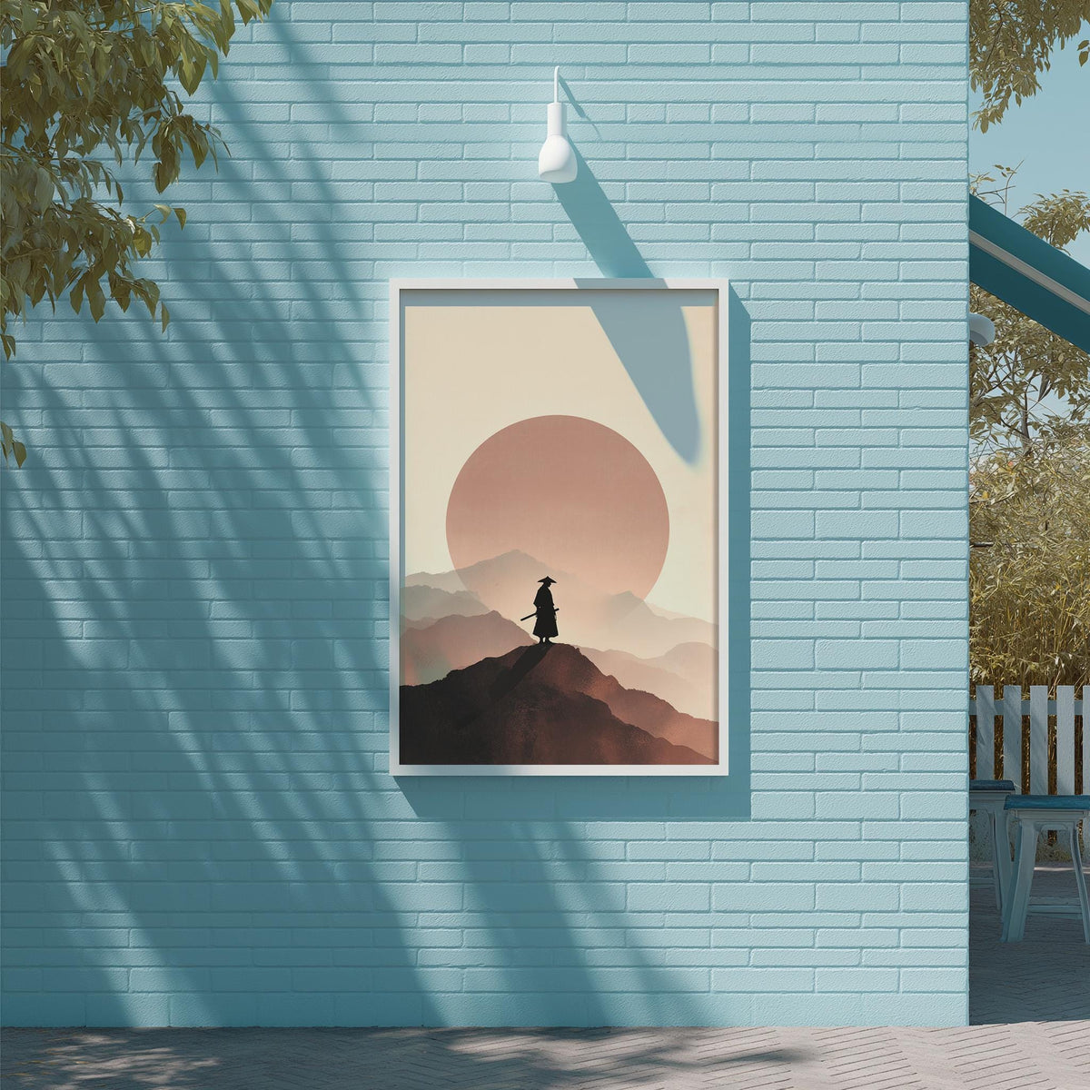 a framed poster of a silhouette of a person standing on a mountain peak, with a large sun in the background.
