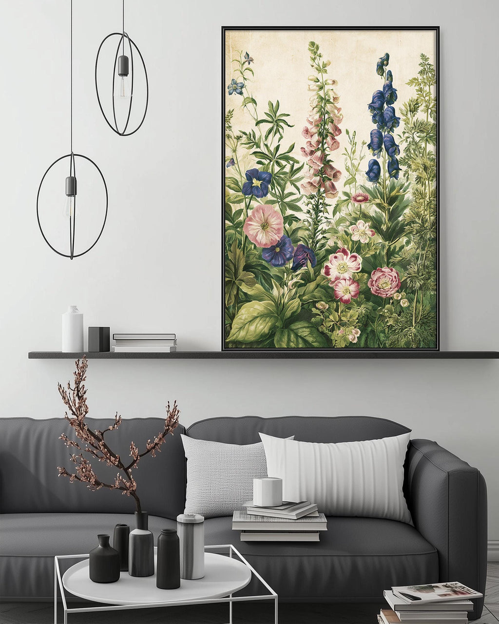 a living room with a gray sofa, a coffee table, and a large framed print of a floral painting hanging on the wall above the sofa.