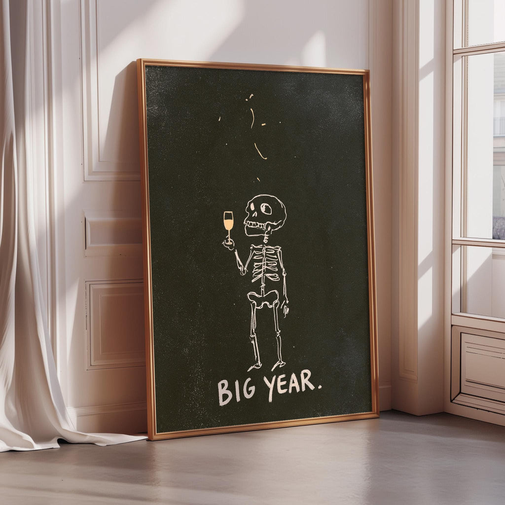 A framed poster with a skeleton holding a wine glass and the text "BIG YEAR."