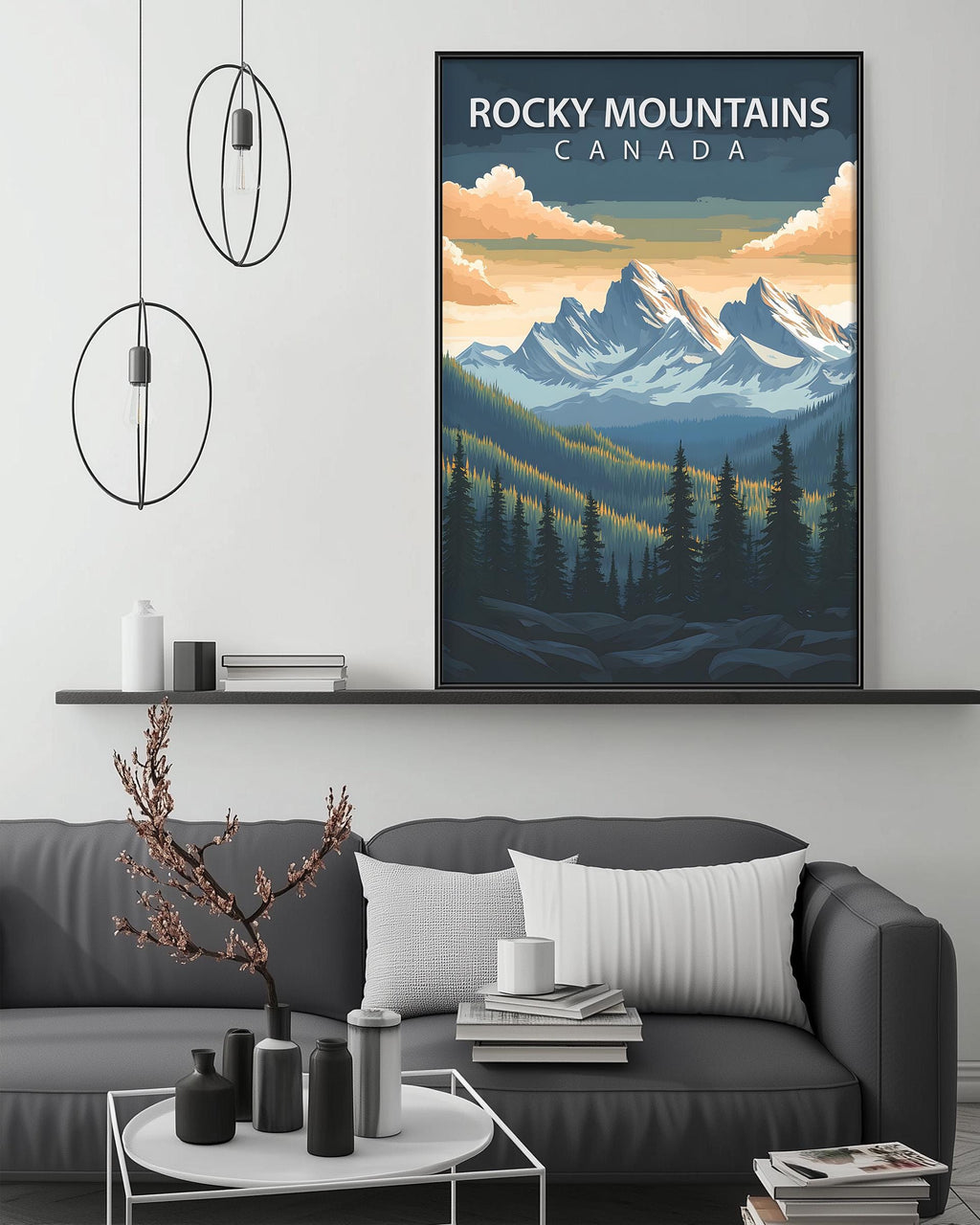 a cozy living room with a gray sofa, a coffee table, and a large framed poster of Rocky Mountains Canada hanging on the wall above the sofa.
