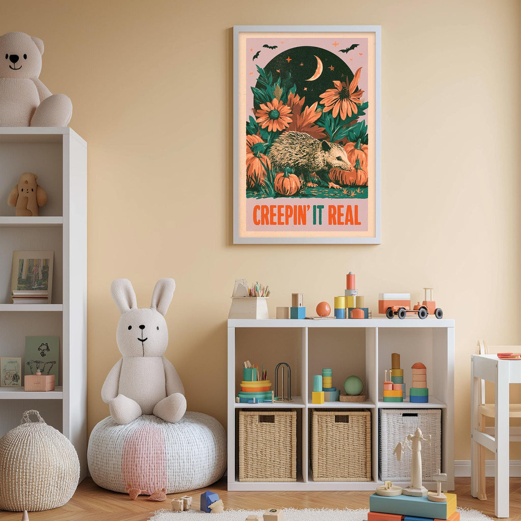 A child's bedroom with a stuffed rabbit, a bookshelf, and a toy train set. The walls are painted a light peach color, and there is a framed poster with a cartoon hedgehog and the text "CREEPIN' IT REAL" hanging on the wall.