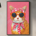 a kitchen counter with a framed picture of a cat wearing sunglasses and a pink scarf hanging on the wall above it.