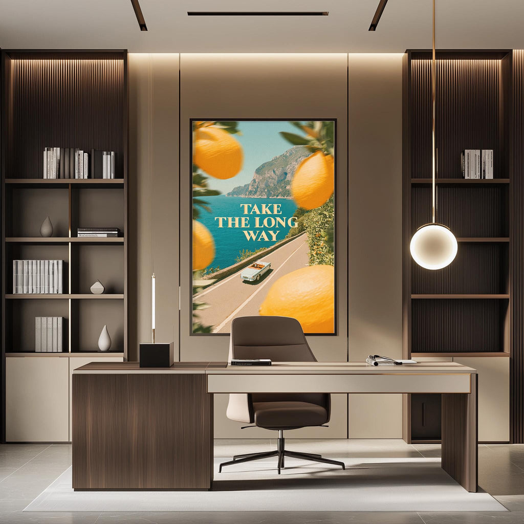 a modern office space with a large framed poster on the wall that says "TAKE THE LONG WAY". The office has a wooden desk, a chair, and a bookshelf. The overall design and decor of the space create a professional and stylish atmosphere.