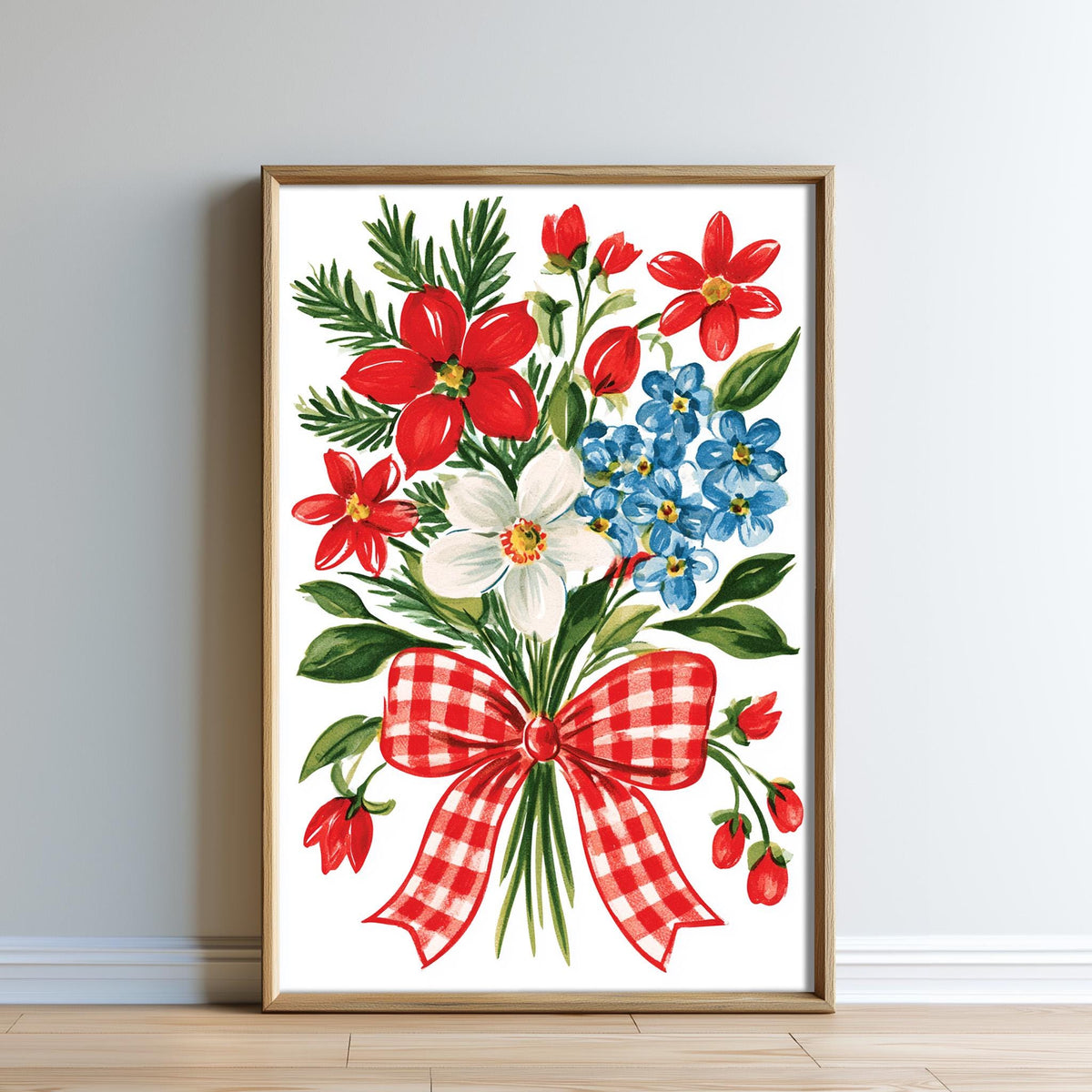 A framed print of a vibrant bouquet of red, white, and blue flowers, with a red and white checkered bow, is displayed on a wall.